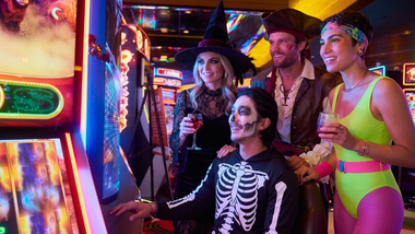 Group wearing Halloween costumes at a slot machine.