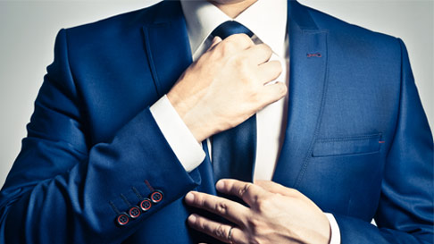 man adjusting tie