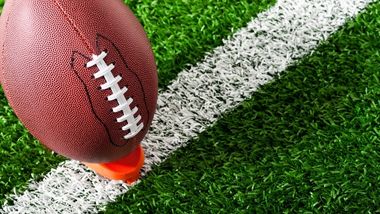 football on tee for kickoff