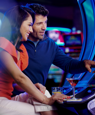 couple playing a slot machine